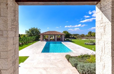 A beautiful stone villa with a swimming pool and a large garden